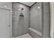 Large shower with gray tile and built-in bench seating at 6770 Cadence Blvd, Atlanta, GA 30328