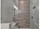 Modern shower with glass enclosure and wood-look tile at 6770 Cadence Blvd, Atlanta, GA 30328