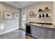 Stylish wet bar with gray cabinets and a wine cooler at 6770 Cadence Blvd, Atlanta, GA 30328