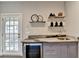 Stylish wet bar with a wine cooler and granite countertop at 6770 Cadence Blvd, Atlanta, GA 30328