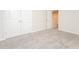 Well-lit bedroom with grey carpeting and double-door closet at 1247 Sunny Lake Dr, Lawrenceville, GA 30043