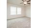 Bright bedroom with carpeted floors, ceiling fan, and two windows at 1247 Sunny Lake Dr, Lawrenceville, GA 30043