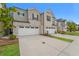 Two-story townhome with brick and siding exterior, two-car garage, and landscaping at 1247 Sunny Lake Dr, Lawrenceville, GA 30043