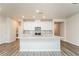 Modern kitchen with white cabinets, granite island, and stainless steel appliances at 1247 Sunny Lake Dr, Lawrenceville, GA 30043