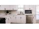 Modern kitchen with white cabinets, quartz countertops, and stainless steel appliances at 2688 Heritage Ln, Morrow, GA 30260