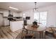 Modern kitchen with island, white cabinets, and a dining area at 2688 Heritage Ln, Morrow, GA 30260