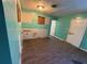 Kitchen under renovation with teal walls and wood floors at 2765 Ocean Valley Dr, Atlanta, GA 30349