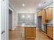 Kitchen with light wood cabinets, granite island, and hardwood floors at 3036 Lassiter Rd, Marietta, GA 30062