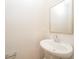 Small bathroom with pedestal sink and mirror at 1267 Sunny Lake Dr, Lawrenceville, GA 30043