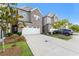 Townhome exterior with gray siding, white garage door, and landscaping at 1267 Sunny Lake Dr, Lawrenceville, GA 30043