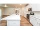 Modern kitchen with white cabinets, quartz countertops, and stainless steel appliances at 1267 Sunny Lake Dr, Lawrenceville, GA 30043