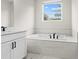 Bathroom with soaking tub and double vanity at 1682 Juniper Berry Way, Loganville, GA 30052