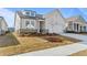 New home with a well-manicured lawn, showing the side entry garage and covered entryway at 1682 Juniper Berry Way, Loganville, GA 30052