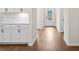 Hardwood floors and white cabinets are featured in this hallway at 1682 Juniper Berry Way, Loganville, GA 30052