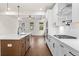 Open kitchen island with wood cabinets and white countertops at 1682 Juniper Berry Way, Loganville, GA 30052