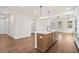 Kitchen island with wood cabinets and a quartz countertop at 1682 Juniper Berry Way, Loganville, GA 30052