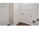 Laundry room with wire shelving and dark brown flooring at 1682 Juniper Berry Way, Loganville, GA 30052