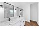 Modern bathroom with white vanity, frameless shower, and dark accents at 1862 Weatherbrook Cir, Lawrenceville, GA 30043