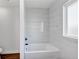 Simple bathroom with a white bathtub and marble-look tile at 1862 Weatherbrook Cir, Lawrenceville, GA 30043