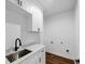 Laundry room with white cabinets and a stainless steel sink at 1862 Weatherbrook Cir, Lawrenceville, GA 30043