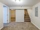 Finished basement with carpet, door, and stairs at 3164 Delmar Nw Ln, Atlanta, GA 30311