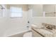 Clean bathroom, granite countertop, white tile, and tub at 3164 Delmar Nw Ln, Atlanta, GA 30311