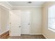 Well-lit bedroom with neutral walls, carpet, and two doors at 3164 Delmar Nw Ln, Atlanta, GA 30311