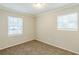 Bright bedroom with neutral walls, carpet, and two windows at 3164 Delmar Nw Ln, Atlanta, GA 30311