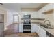 Renovated kitchen with white cabinets, granite countertops, and stainless steel appliances at 3164 Delmar Nw Ln, Atlanta, GA 30311