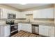 Renovated kitchen with white cabinets, granite countertops, and stainless steel appliances at 3164 Delmar Nw Ln, Atlanta, GA 30311