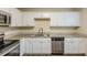 Renovated kitchen with white cabinets, granite countertops, and stainless steel appliances at 3164 Delmar Nw Ln, Atlanta, GA 30311