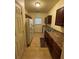 The kitchen has brown cabinets, tile flooring, and white appliances at 6518 Grey Fox Way, Riverdale, GA 30296