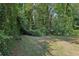 Large backyard with lush green grass and mature trees at 1626 Kenmore Sw St, Atlanta, GA 30311