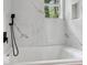 Bathroom with a soaking tub and marble shower surround at 1626 Kenmore Sw St, Atlanta, GA 30311