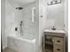 Bathroom with soaking tub and marble tile at 1626 Kenmore Sw St, Atlanta, GA 30311