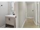 Updated bathroom with vanity and hallway view at 1626 Kenmore Sw St, Atlanta, GA 30311