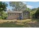 Gray house exterior with a small yard and trees in the background at 1626 Kenmore Sw St, Atlanta, GA 30311