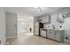 Modern kitchen with gray cabinets, white backsplash and stainless steel appliances at 1626 Kenmore Sw St, Atlanta, GA 30311