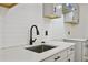 Modern kitchen sink with black faucet and white quartz countertop at 1626 Kenmore Sw St, Atlanta, GA 30311
