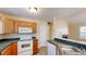 Kitchen features wood cabinets, white appliances, and a sink at 4002 Cheoah Dr, Douglasville, GA 30135