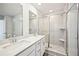 Bathroom featuring double sinks, quartz countertops, and a tiled shower, providing a sleek and modern design at 4178 Waratah Way, Mableton, GA 30126