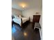 Well-lit bedroom with dark hardwood floors and a king-size bed at 782 Post Road Way, Stone Mountain, GA 30088