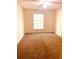 Well-lit bedroom with carpeted floor and large window at 79 Place Fontaine, Lithonia, GA 30038