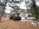 Side view of a light gray single story house with a snow covered yard at 1783 Nicole Ln, Lithonia, GA 30058