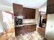 Older kitchen with dark wood cabinets and vinyl floor at 1783 Nicole Ln, Lithonia, GA 30058