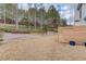 Spacious backyard with wooden retaining wall and privacy fence at 3640 Rolling Creek Dr, Buford, GA 30519