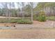 Landscaped backyard with wooden retaining wall at 3640 Rolling Creek Dr, Buford, GA 30519