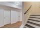 Basement hallway with light wood floors and two closed doors at 3640 Rolling Creek Dr, Buford, GA 30519