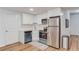 Modern basement kitchenette with stainless steel appliances and white cabinets at 3640 Rolling Creek Dr, Buford, GA 30519