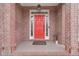 Red front door entryway with brick columns at 3640 Rolling Creek Dr, Buford, GA 30519